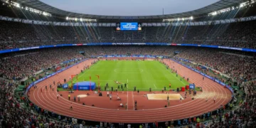 Athletes competing in a vibrant stadium at the 2026 World Athletics Championships, showcasing the excitement and scale of the event.