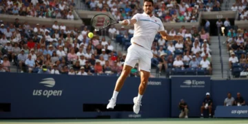 Male tennis player serves during a US Open qualification match
